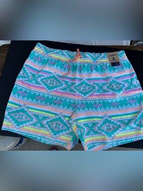 chubbies white swim shorts with teal and neon yellow patterned waistband